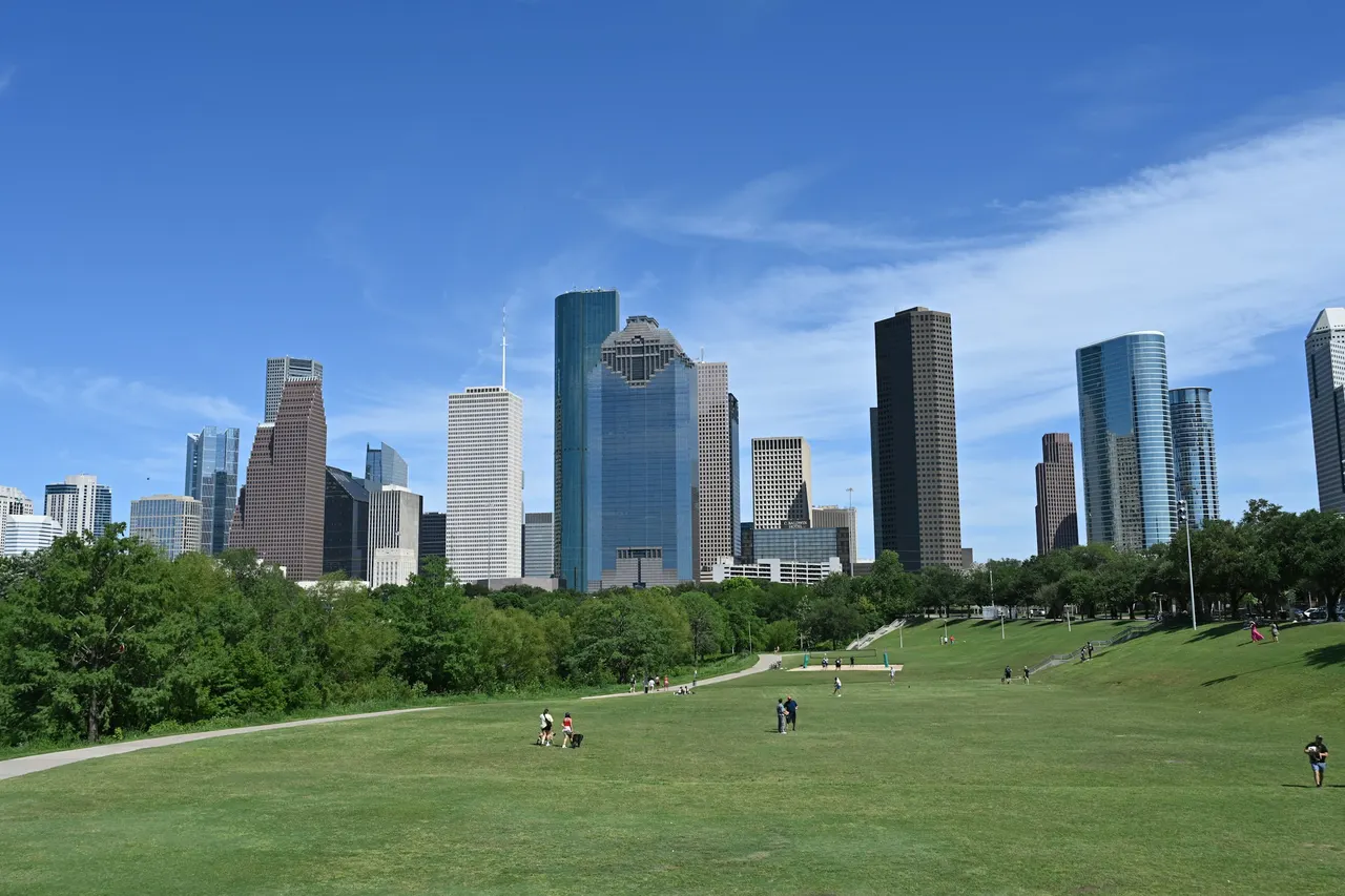 Downtown Houston skyline beyond green parkland; regional orientation, not a service location
